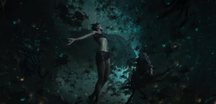 A female scientist floats in the air, surrounded by thousands of alien creatures