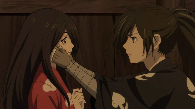 A young samurai man clutches the face of a young woman