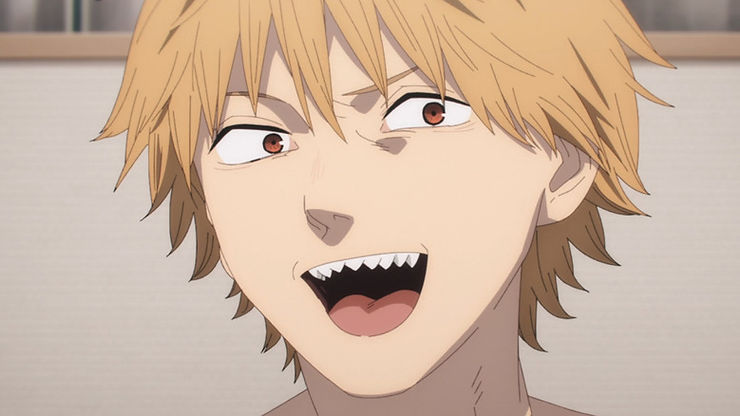 A man with blodish-brown hair, brown eyes, and sharp teeth smiles with his mouth open. Denji from Chainsaw Man.