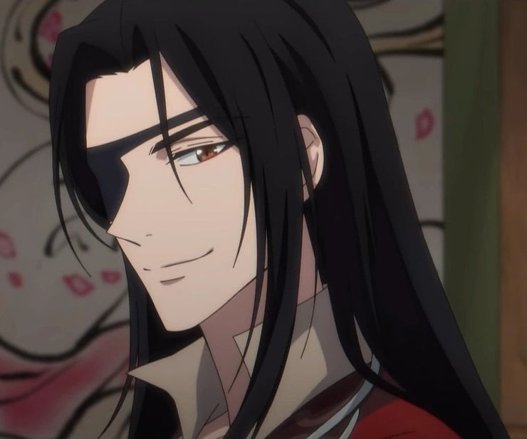 Hua Cheng, a man with a black eyepatch and long black hair, smirks at the screen. From Heaven Official's Blessing animation.