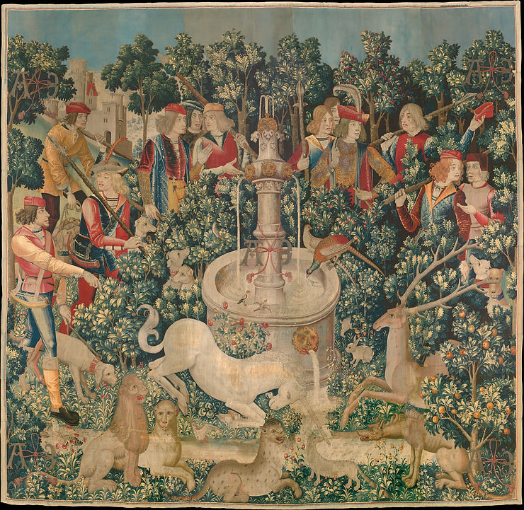 Numerous hunters carrying weapons surround a unicorn purifying a water fountain in the presence of pheasants, a stag, and lions in the Unicorn tapestry called "The Unicorn is Found"